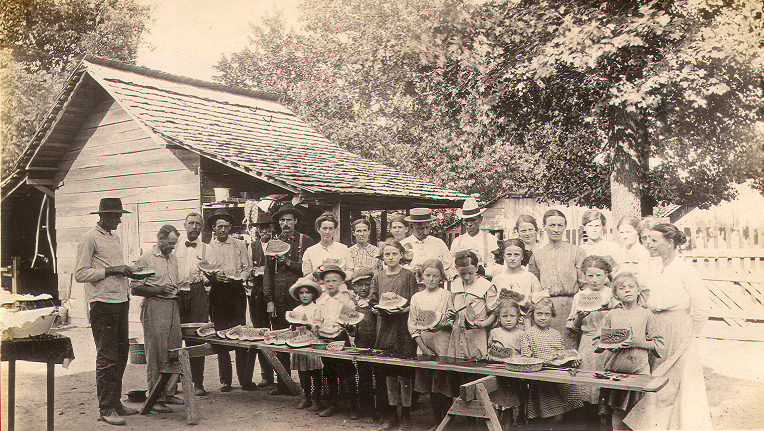 Group eating watermelon, ca. 1915. From the Mablevale Home Demonstration Club Records (MC 1640), box 5, folder 1, image 57, Special Collections, University of Arkansas Libraries. 