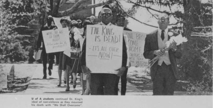 "The King is Dead: It's All Over Now" [ Photograph of marchers protesting the death of Martin Luther King, Jr. ] Razorback Yearbook 1968 http://digitalcollections.uark.edu/cdm/singleitem/collection/Civilrights/id/182/rec/10